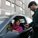 A policeman asks a woman wearing bright coloured clothes for her identification papers at a morals police checkpoint in Tehran June 16, 2008.